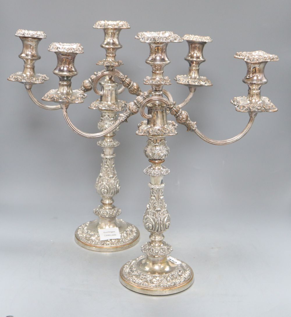 A pair of old Sheffield plate two branch three light candelabra, height 43cm